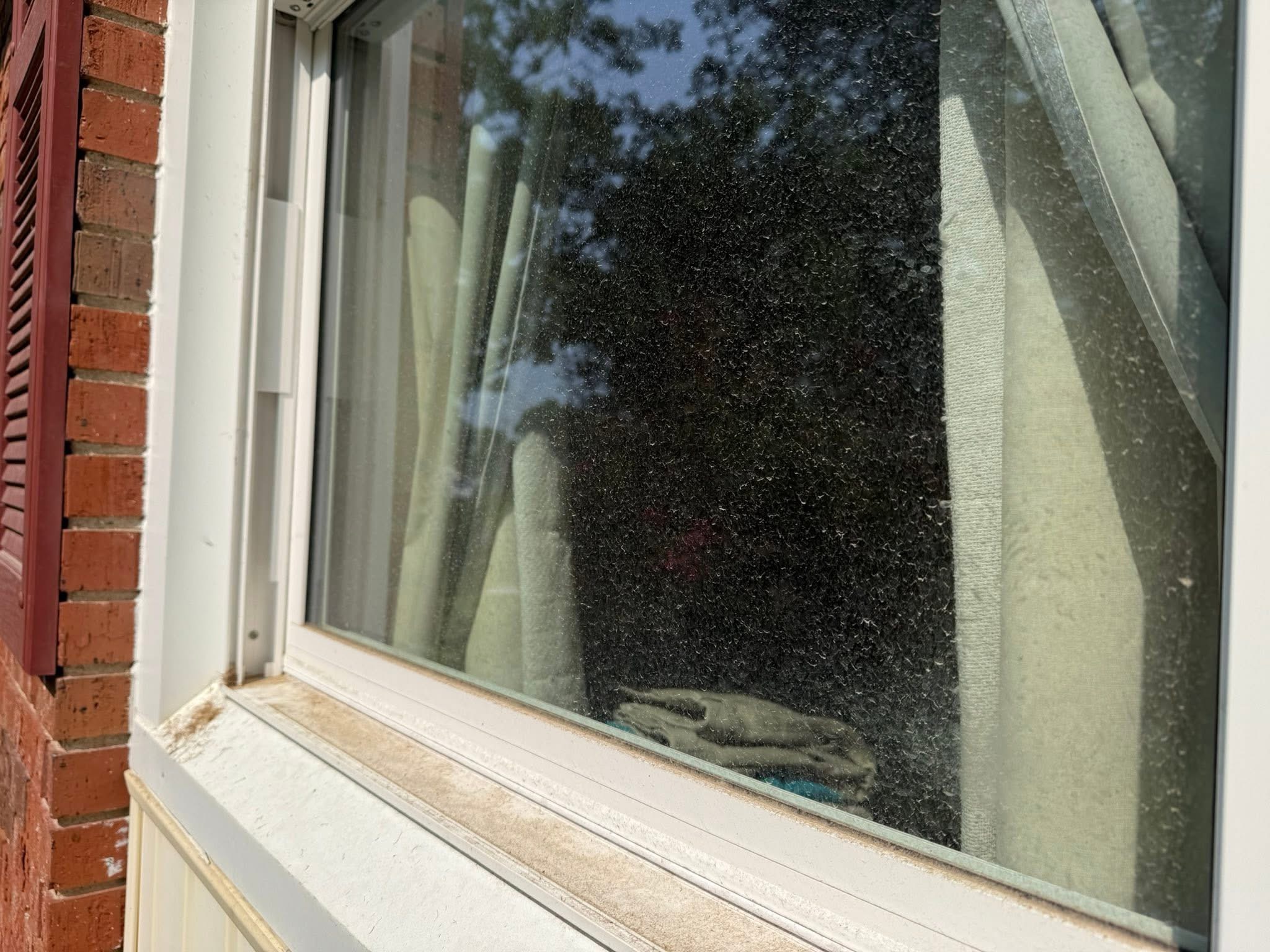 Window with dust and streaks before cleaning